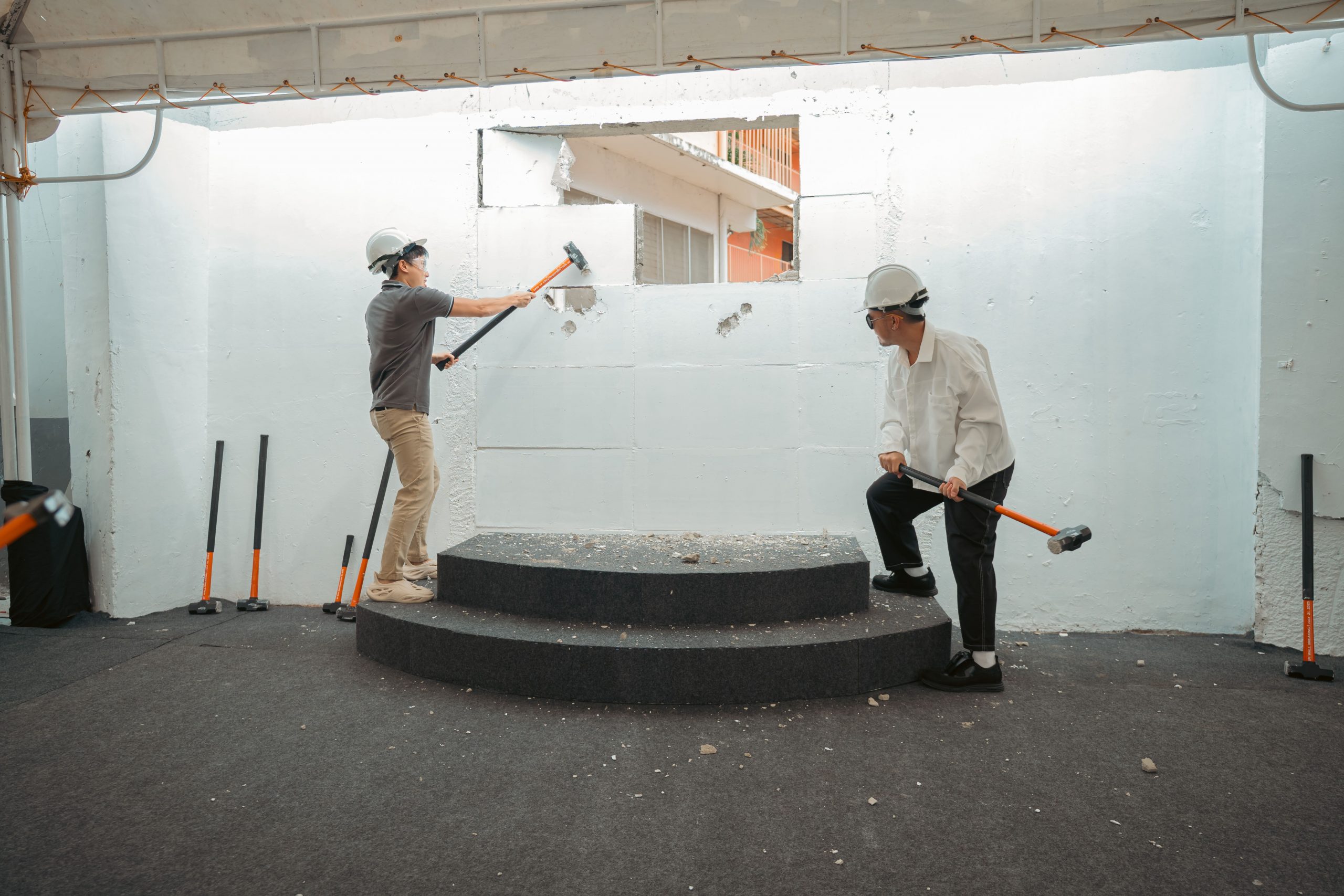 Jeremiah Tan with Kyle Wong as they take a swing at the wall